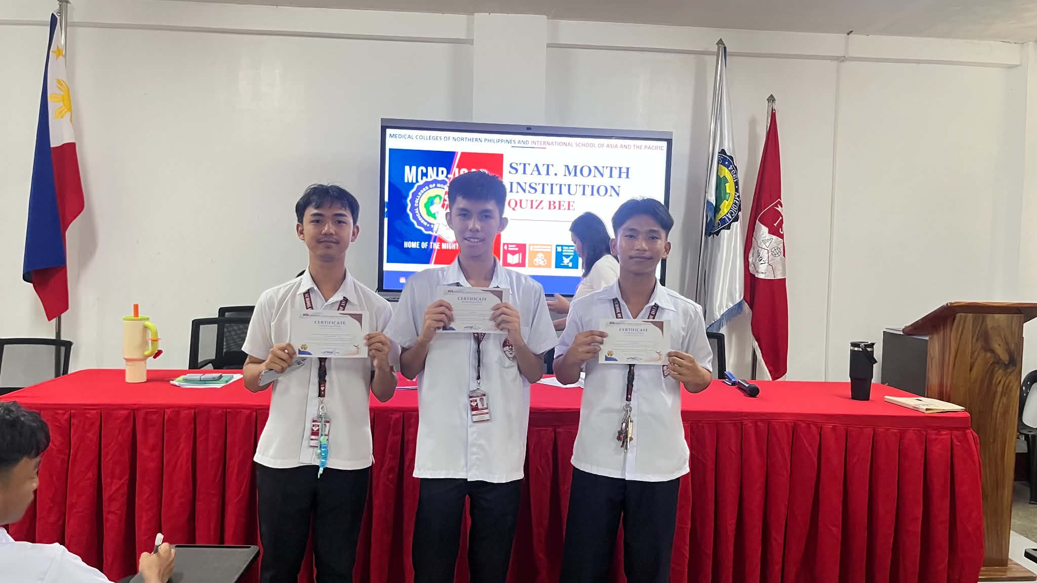 ISAP Quiz Bee Winners holding certificates on stage