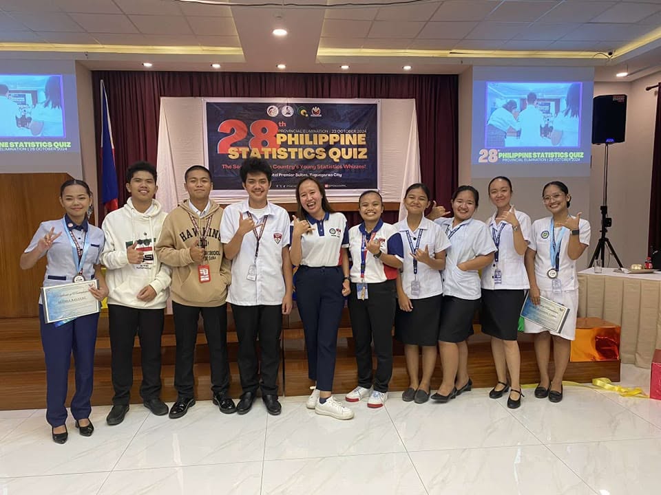 Statistics Quiz Bee participants with coach